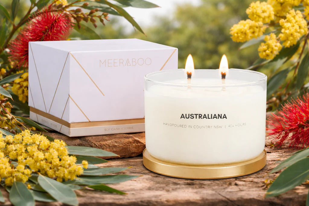 Meeraboo Gold Lid Soy Candle in a clear glass vessel with a brushed gold lid and double wicks, hand-poured with soy wax for long-lasting fragrance.
