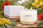 Meeraboo Gold Lid Soy Candle in a clear glass vessel with a brushed gold lid and double wicks, hand-poured with soy wax for long-lasting fragrance.
