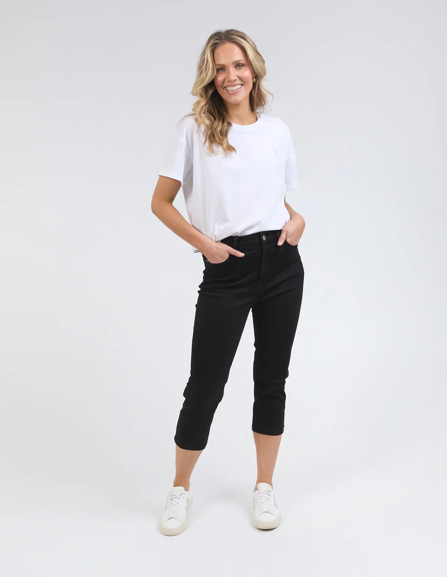 Black Mollie Capri Jeans featuring a slim, cropped leg for a flattering fit. Made from soft stretch denim with a classic 5-pocket design, calf-length cut, and Elm-stamped hardware. The comfortable button-and-fly fastening makes them a practical choice for effortless style. Crafted from 78% cotton, 20% polyester, and 2% elastane for a perfect balance of comfort and flexibility.