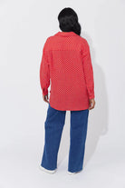 Vanuatu Shirt in Chilli with a relaxed fit, subtle square print, curved hem, and rolled tab sleeves showing a contrast colour block.