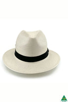 Clarence Glazed Straw Fedora in ivory with 6.5cm brim, 11cm crown, deep navy ribbon band with side detail, and ComfyFit adjustable internal band.
