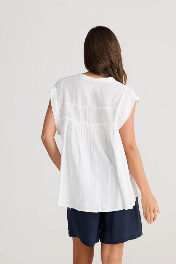 A woman modelling the Clementine Short Sleeve White Top by Holiday from behind