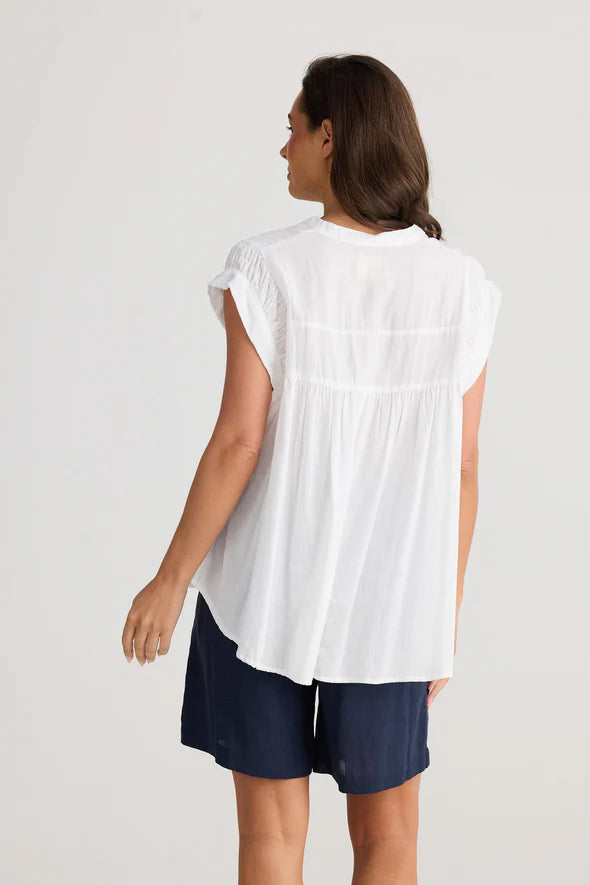 A woman modelling the Clementine Short Sleeve White Top by Holiday from behind