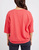 The Coral Spritz Mazie Sweat by Elm is available at Rawspice Boutique.