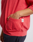 The Coral Spritz Mazie Sweat by Elm is available at Rawspice Boutique.