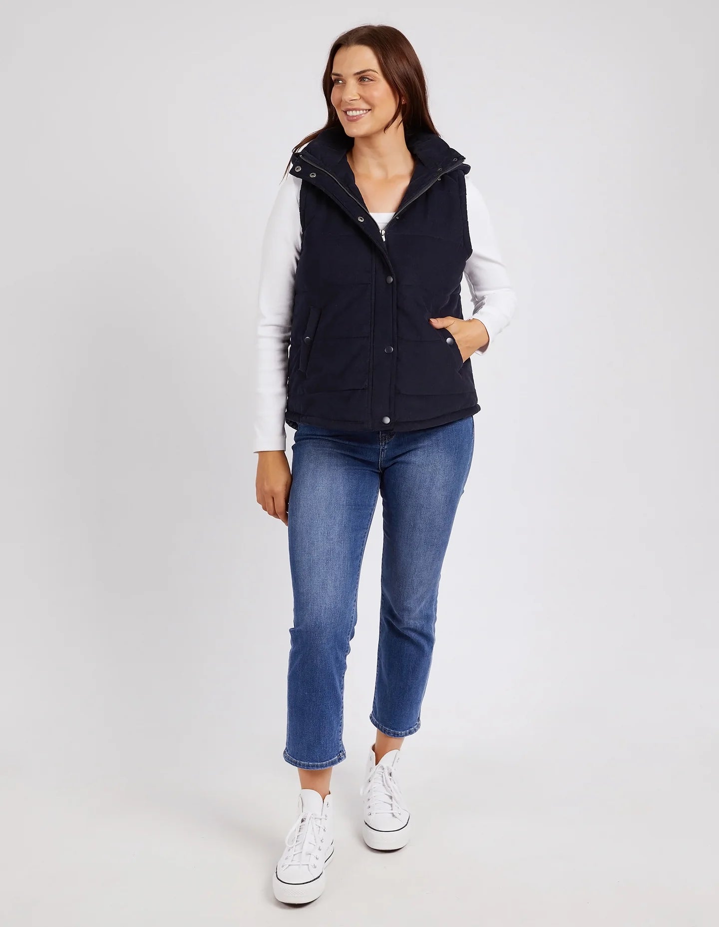 Cord Puffer Vest in Dark Sapphire made from pinwhale cord, featuring a padded design and hood for added warmth.