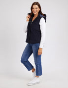 Cord Puffer Vest in Dark Sapphire made from pinwhale cord, featuring a padded design and hood for added warmth.