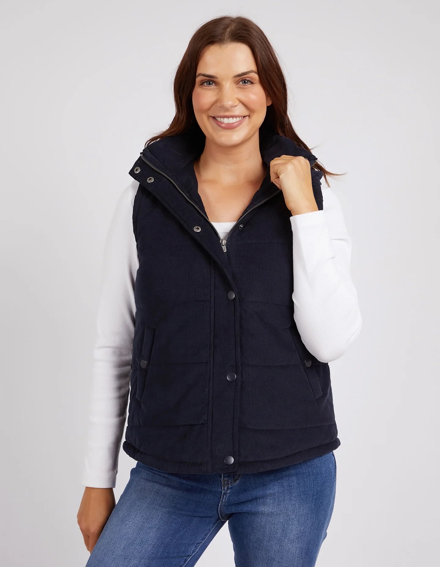 Cord Puffer Vest in Dark Sapphire made from pinwhale cord, featuring a padded design and hood for added warmth.