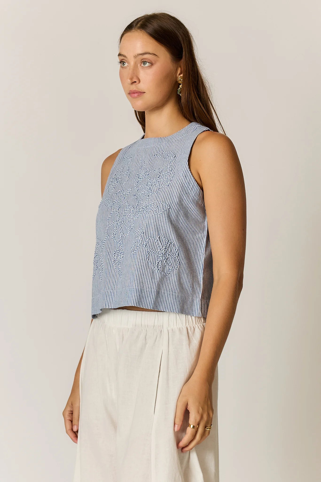 Cornelli Top featuring delicate embroidery and a sleeveless design, available in blue stripe, pink stripe and black.
