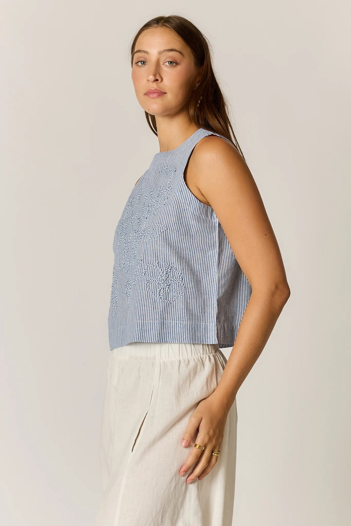 Cornelli Top featuring delicate embroidery and a sleeveless design, available in blue stripe, pink stripe and black.
