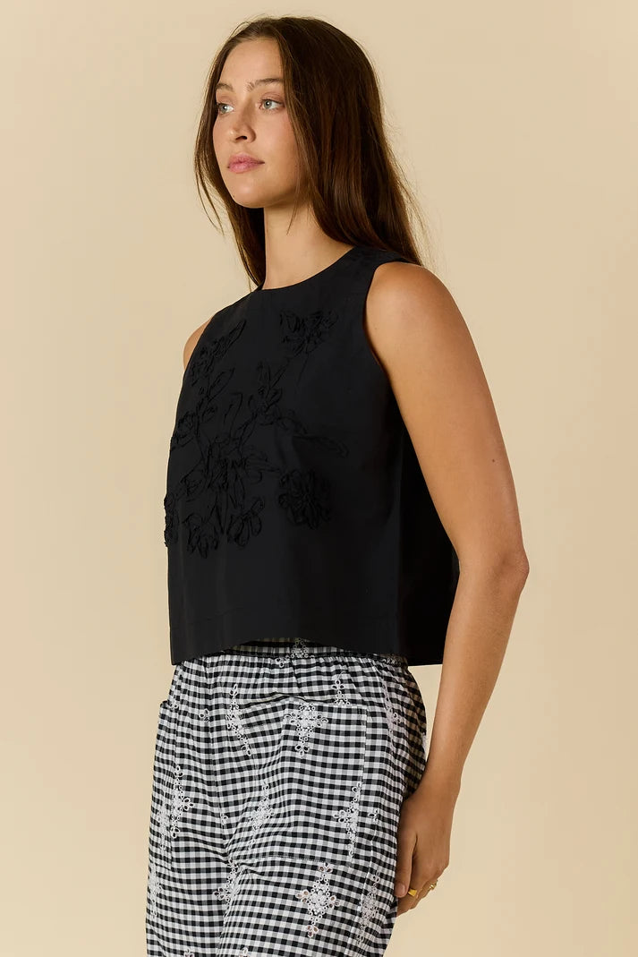 Cornelli Top featuring delicate embroidery and a sleeveless design, available in blue stripe, pink stripe and black.
