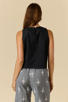 Cornelli Top featuring delicate embroidery and a sleeveless design, available in blue stripe, pink stripe and black.
