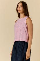 Cornelli Top featuring delicate embroidery and a sleeveless design, available in blue stripe, pink stripe and black.
