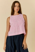 Cornelli Top featuring delicate embroidery and a sleeveless design, available in blue stripe, pink stripe and black.
