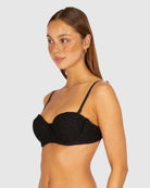 A black balconette bikini top with moulded underwire cups, boning support, and removable adjustable straps, crafted from textured crochet fabric.