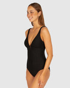 A stylish crochet-textured one-piece swimsuit with a dropped neckline, copper ring detail, and supportive under-bust panel for a chic, vintage-inspired look.