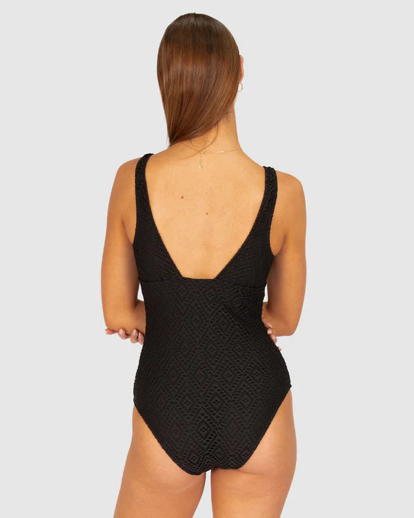 A stylish crochet-textured one-piece swimsuit with a dropped neckline, copper ring detail, and supportive under-bust panel for a chic, vintage-inspired look.