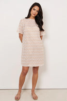 Kaia Daisy Chain A-Line Dress in Natural with daisy lace, round neckline, mid sleeves, slip lining, and button-loop back closure.