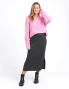 Charcoal marle knit skirt with calf-length cut, side splits, and an elastic waist, offering a flattering and versatile fit for every season.
