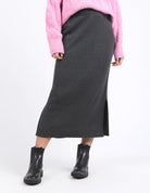 Charcoal marle knit skirt with calf-length cut, side splits, and an elastic waist, offering a flattering and versatile fit for every season.