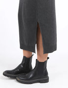 Charcoal marle knit skirt with calf-length cut, side splits, and an elastic waist, offering a flattering and versatile fit for every season.