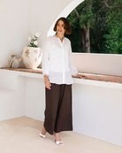 Ramie top featuring an embroidered collar and cuffs, notched neckline, gathered blouson sleeves and button-through front.