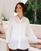 Ramie top featuring an embroidered collar and cuffs, notched neckline, gathered blouson sleeves and button-through front.