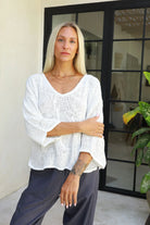 Estelle Hessian V Neck Top in natural white with 3/4 sleeves, V-neckline and scalloped hemline in textured handwoven cotton rayon fabric.