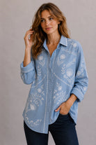 Feather Embroidery Shirt in soft chambray linen with hand-designed floral embroidery, classic collar and relaxed oversized fit.