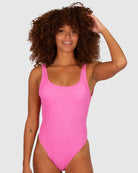 A bold flamingo-pink one-piece swimsuit with a low back, elongated leg line, Rio bottom coverage, and textured Italian fabric for a stylish, flattering fit.