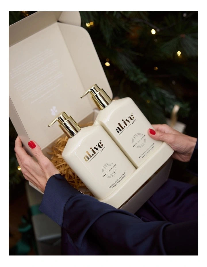 The Al.ive Wash & Lotion Duo in Golden Wattle & Citrus, featuring a 500ml Hand & Body Wash and a 500ml Hand & Body Lotion, elegantly displayed on a matching tray. The bottles are adorned with gold accents, reflecting a festive champagne-inspired design. The duo offers a refreshing blend of citrus and warm native botanicals, providing an indulgent, nourishing experience for the skin.
