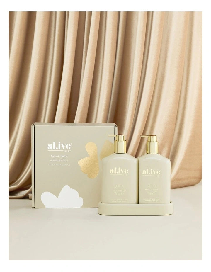 The Al.ive Wash & Lotion Duo in Golden Wattle & Citrus, featuring a 500ml Hand & Body Wash and a 500ml Hand & Body Lotion, elegantly displayed on a matching tray. The bottles are adorned with gold accents, reflecting a festive champagne-inspired design. The duo offers a refreshing blend of citrus and warm native botanicals, providing an indulgent, nourishing experience for the skin.
