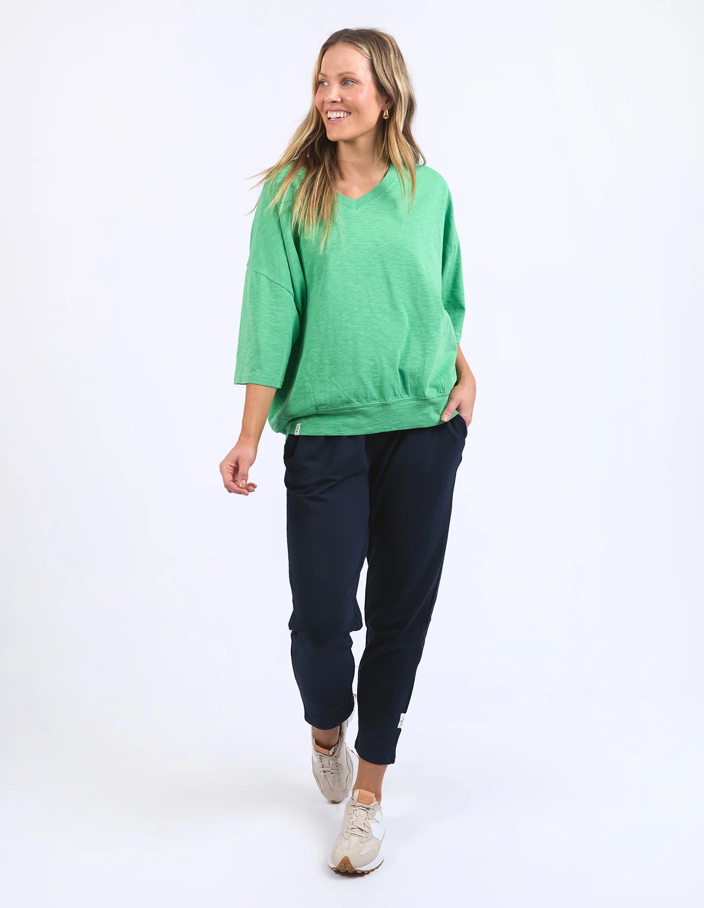 The Mazie Vee Neck in Greenbriar, a relaxed-fit cotton top with a spacious oversized design, features a flattering V-neckline, 3/4 length sleeves, and two front pockets, perfect for layering or casual wear