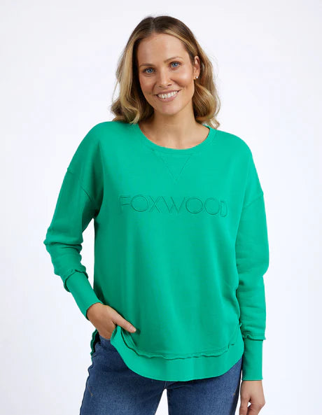 Foxwood Simplified Crew in bright green with round neck, raw edge details, and side splits for a relaxed, everyday look.