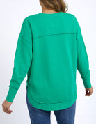 Foxwood Simplified Crew in bright green with round neck, raw edge details, and side splits for a relaxed, everyday look.