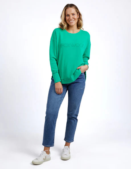 Foxwood Simplified Crew in bright green with round neck, raw edge details, and side splits for a relaxed, everyday look.