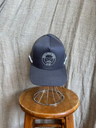 Rocks Hat in black featuring a whale tail design on the front, snapback closure, and breathable mesh sides for a comfortable, adjustable fit.