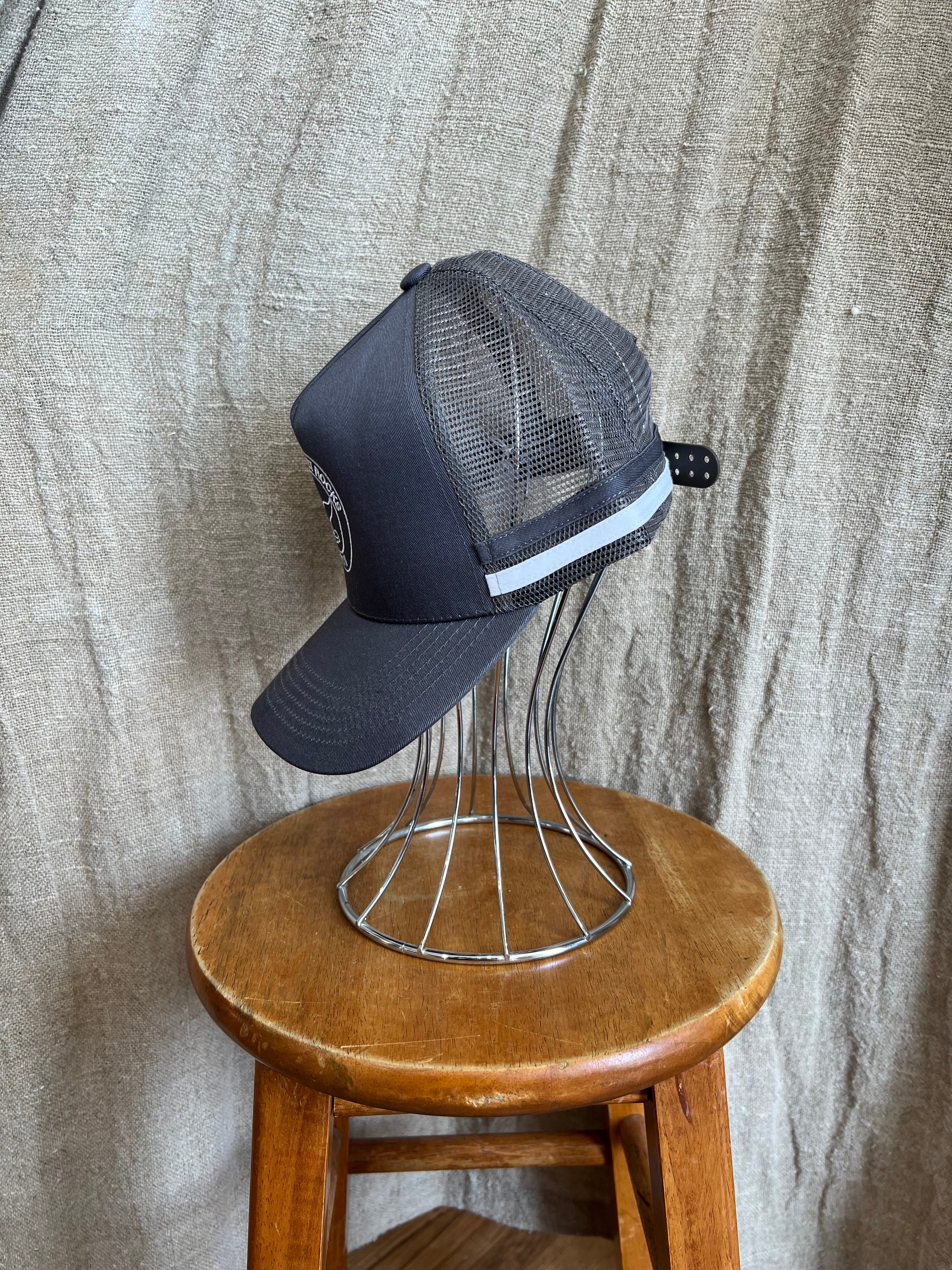 Rocks Hat in black featuring a whale tail design on the front, snapback closure, and breathable mesh sides for a comfortable, adjustable fit.