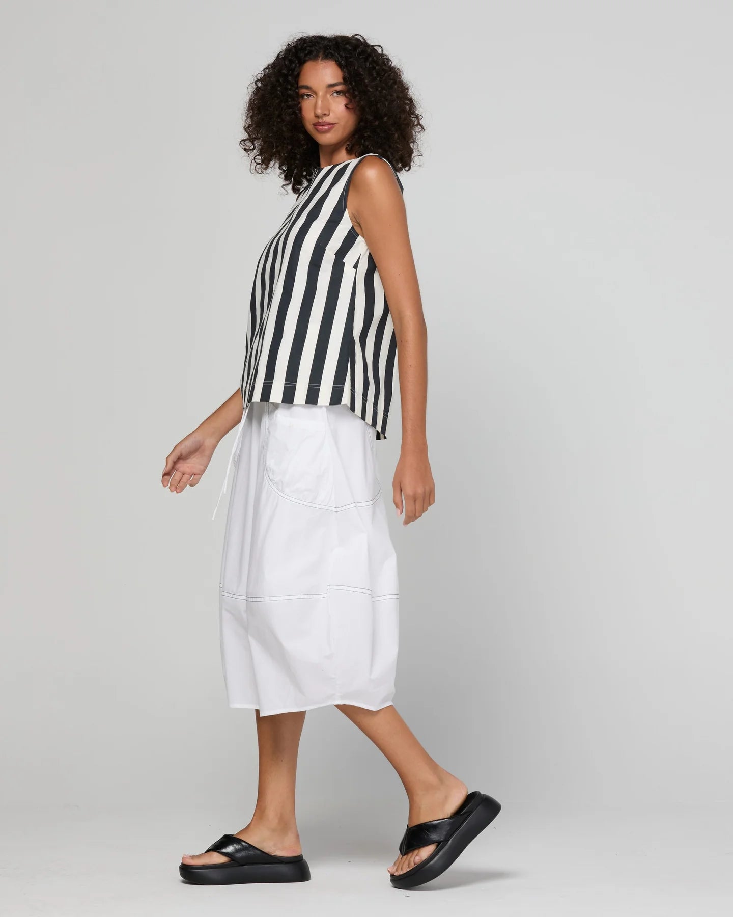 Guru Skirt in Coconut featuring a 3/4 length, stretch drawstring waistband, front and back pockets, full lining and black contrast stitching.