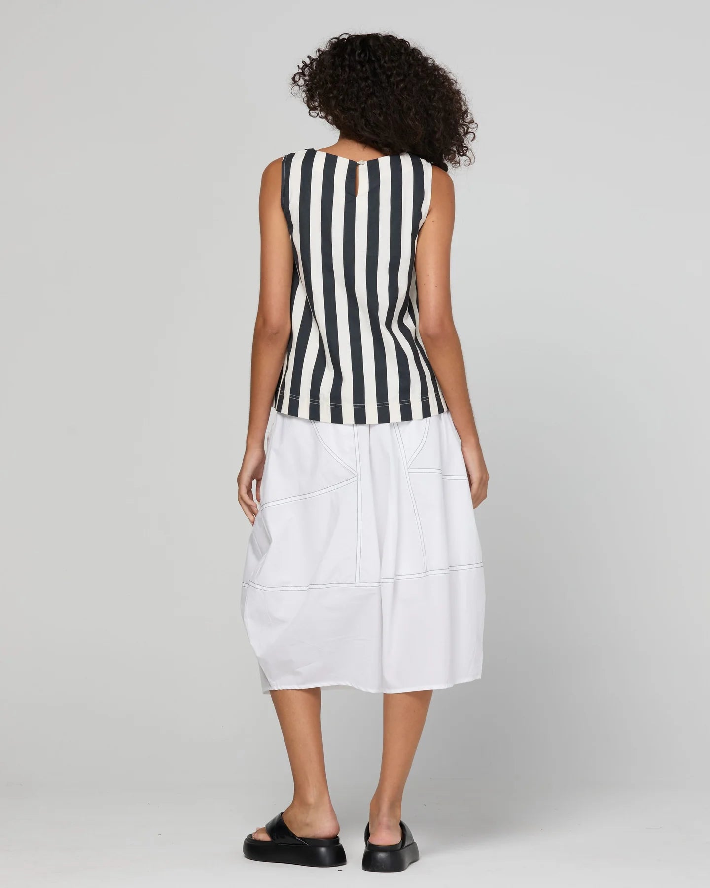 Guru Skirt in Coconut featuring a 3/4 length, stretch drawstring waistband, front and back pockets, full lining and black contrast stitching.
