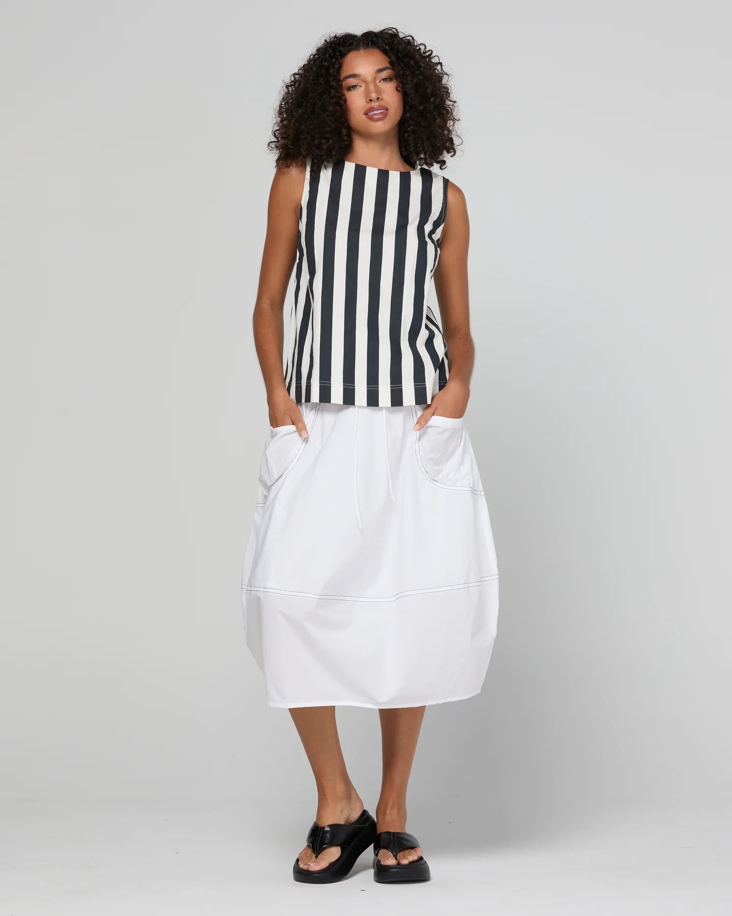 Guru Skirt in Coconut featuring a 3/4 length, stretch drawstring waistband, front and back pockets, full lining and black contrast stitching.