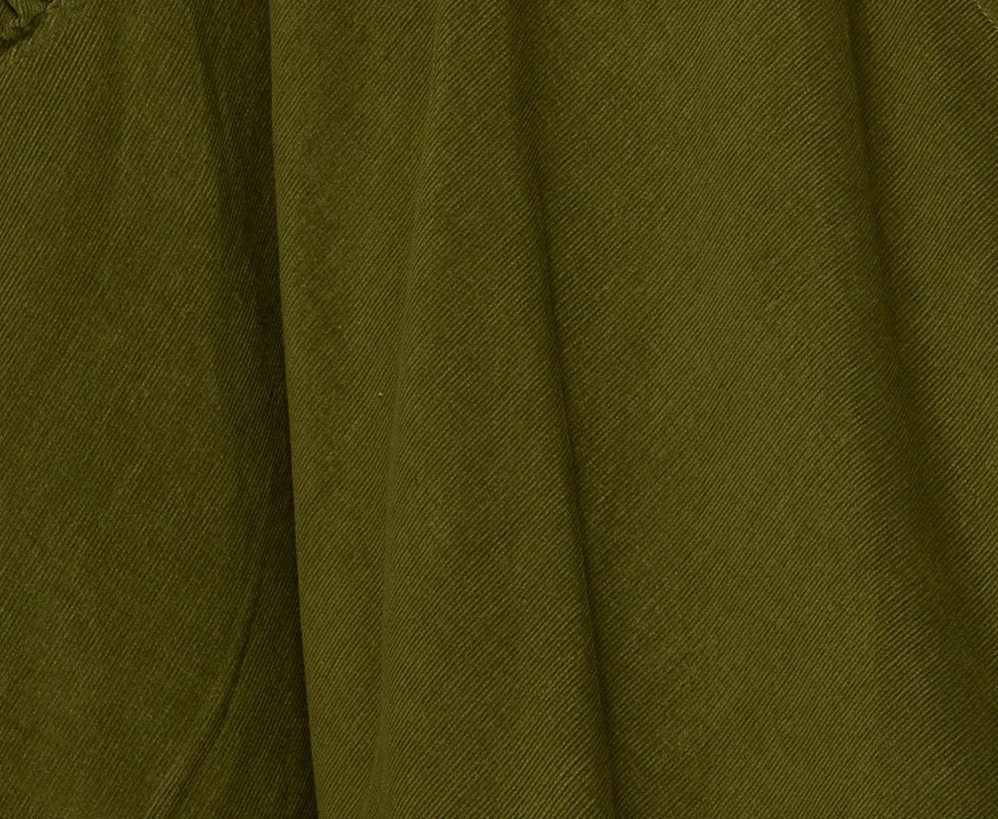 Woman wearing the Cord Guru Pant in Olive Green, featuring a relaxed 3/4 balloon-leg fit in soft cotton cord with a cool-toned khaki finish.