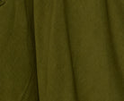 Woman wearing the Cord Guru Pant in Olive Green, featuring a relaxed 3/4 balloon-leg fit in soft cotton cord with a cool-toned khaki finish.