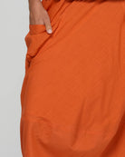 Guru Skirt in Rust, featuring a 3/4 length, stretch drawstring waistband, front and back pockets, full lining and black contrast stitching.