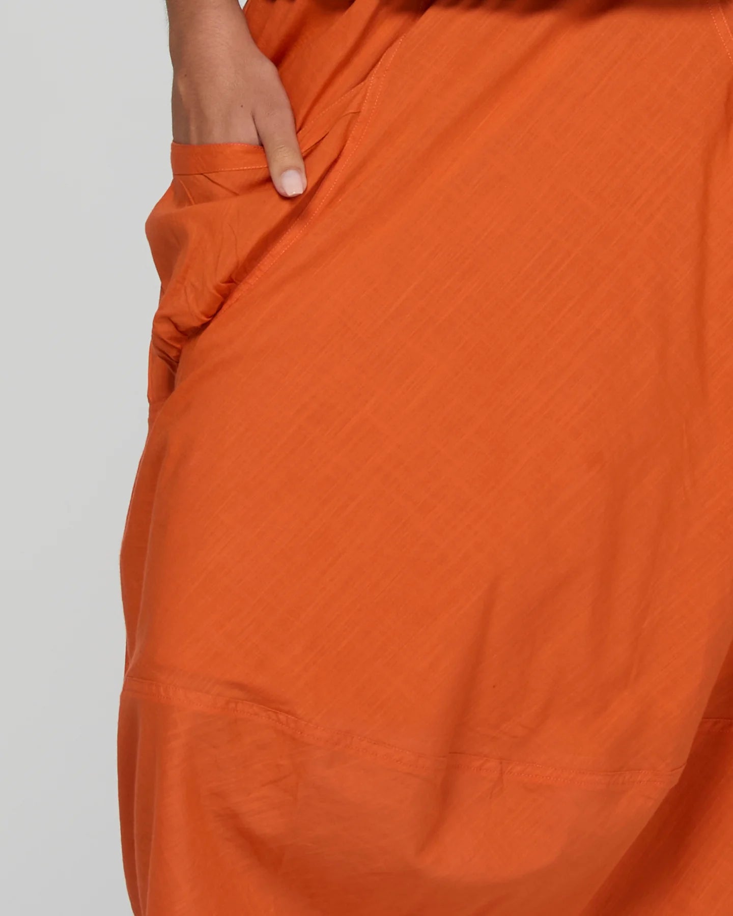 Guru Skirt in Rust, featuring a 3/4 length, stretch drawstring waistband, front and back pockets, full lining and black contrast stitching.