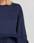 Oversized cropped Guru Sweater with balloon sleeves, contrast stitching, raw seam details, and ribbed neckline, cuffs, and hem with SMILE logo