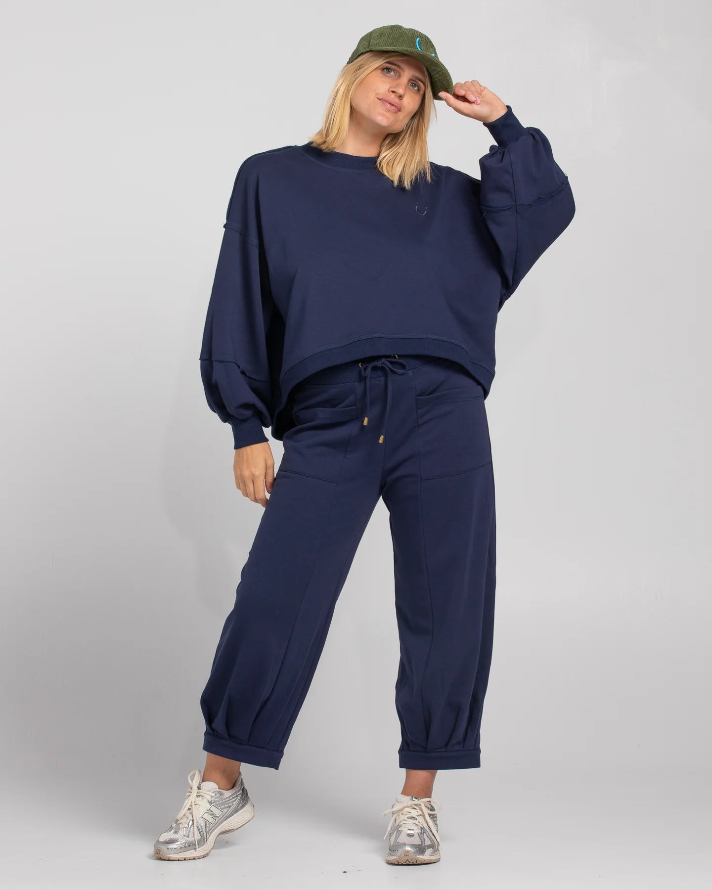 Oversized cropped Guru Sweater with balloon sleeves, contrast stitching, raw seam details, and ribbed neckline, cuffs, and hem with SMILE logo