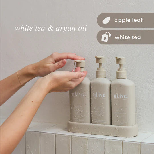 Hair & Body Trio – Hydrate featuring sulfate-free shampoo, nourishing conditioner, and rich body wash in a neutral stone-colored set.
