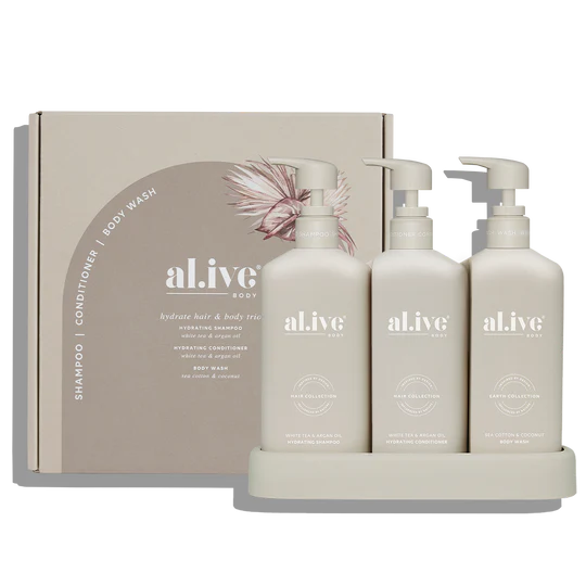 Hair & Body Trio – Hydrate featuring sulfate-free shampoo, nourishing conditioner, and rich body wash in a neutral stone-colored set.
