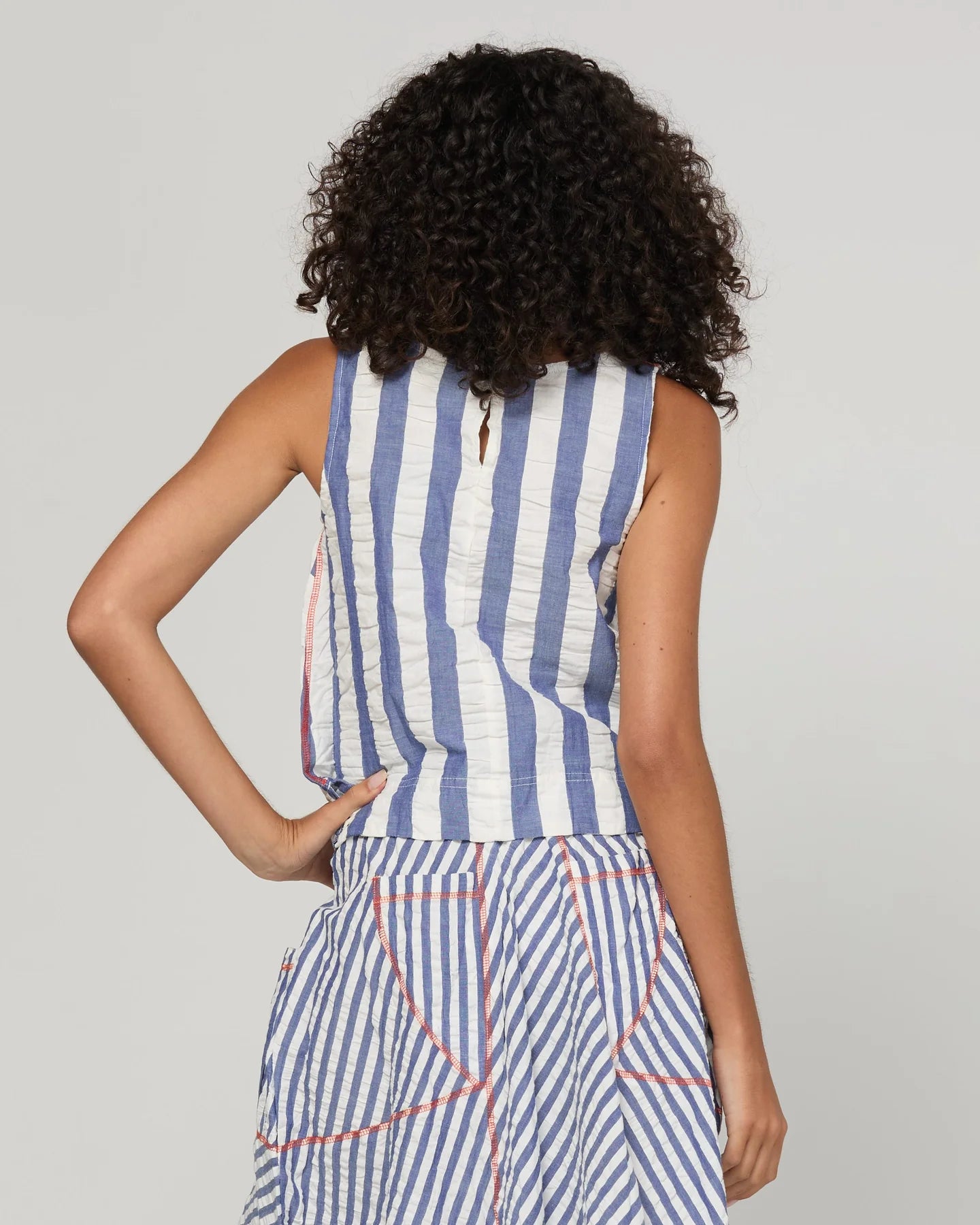 Boom Shankar Hara Top in Ocean Stripe featuring vertical stripes, a high scoop neckline, sleeveless design and fitted silhouette.
